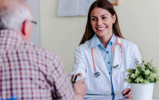 Older,Patient,At,Woman,Doctor,Office,Paying,Exam,With,Credit